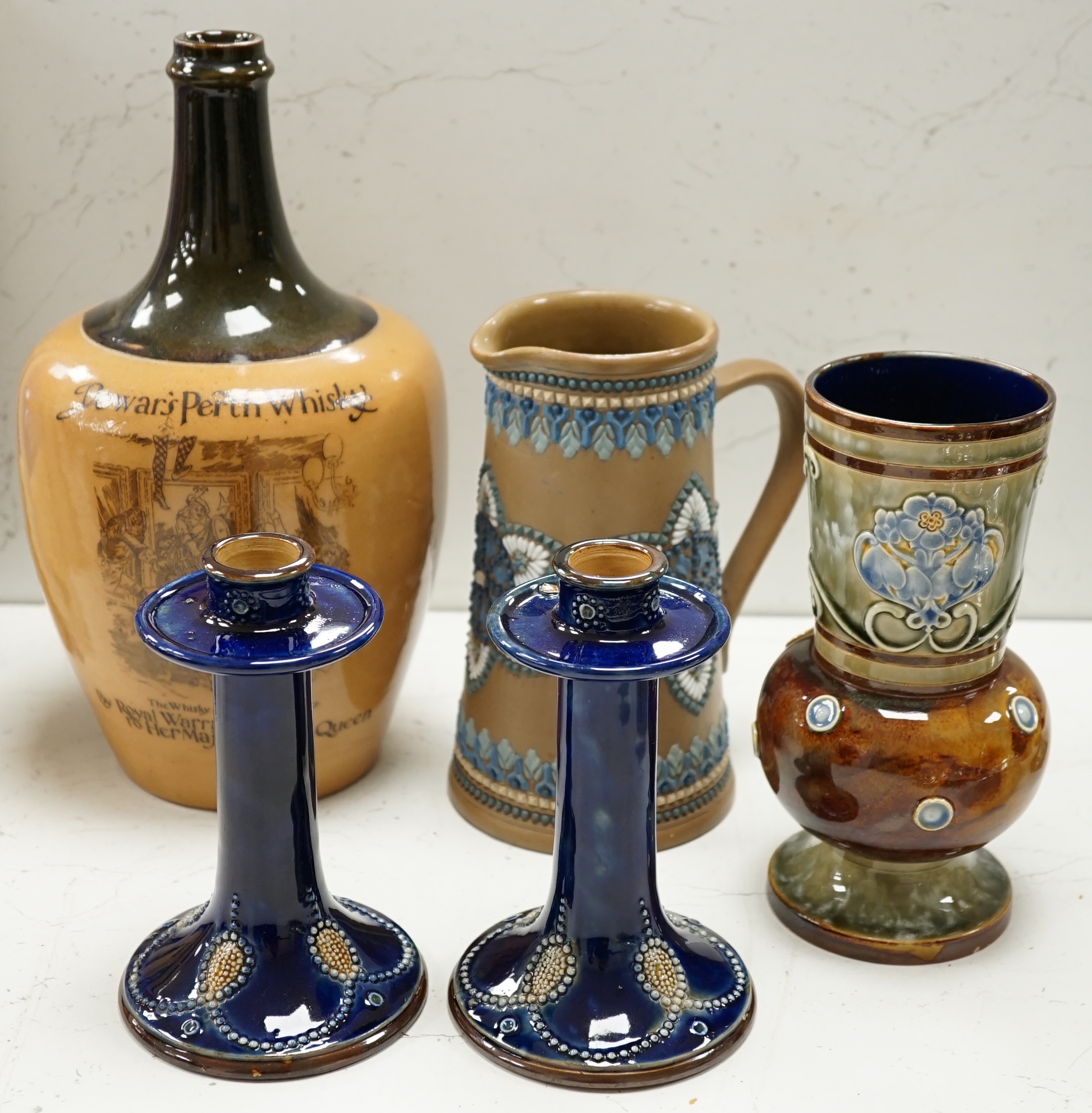 A Doulton Lambeth Dewars Perth whisky flagon, a pair of candlesticks and two other pieces, tallest 29cm. Condition - mostly good, one or two small chips